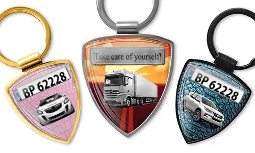 Shield-shaped photo keychain with car and truck designs
