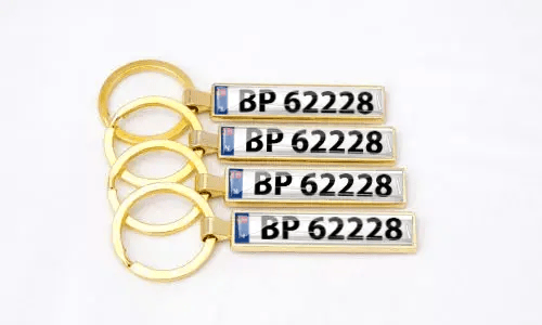 Gold metal license plate keychains highlight personalized car accessories