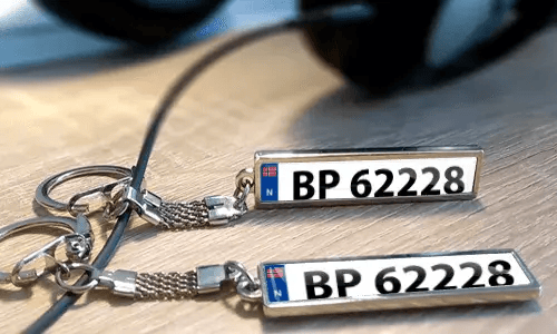 Personalized metal keychains with custom text and license plate style tags