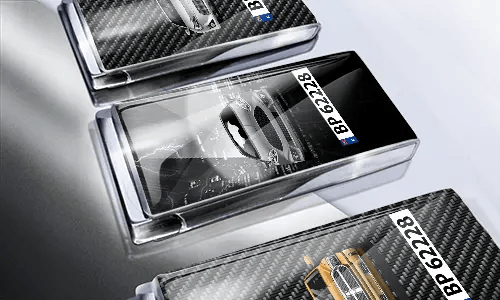 Three car-themed boxes with glossy finish: silver with car, black with cityscape and black car, red with car front
