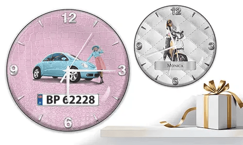 Two wall clocks with female figures and vehicles: left with black car on purple waves, right with red and black cars, racing flags, and blue background