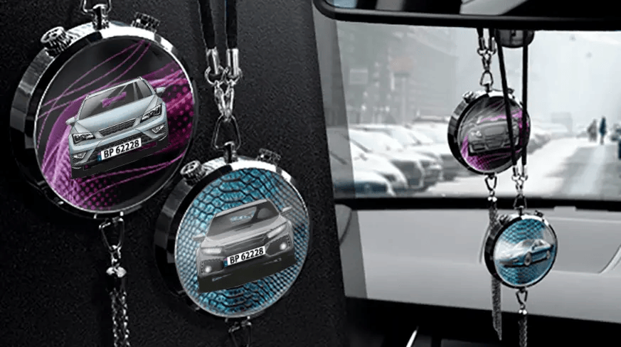 Two circular car air fresheners hanging from rearview mirror: left with black car, right with blue car