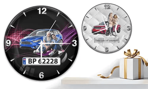 Two wall clocks with couples and cars: left with blue car and purple waves, right with red car on quilted white background
